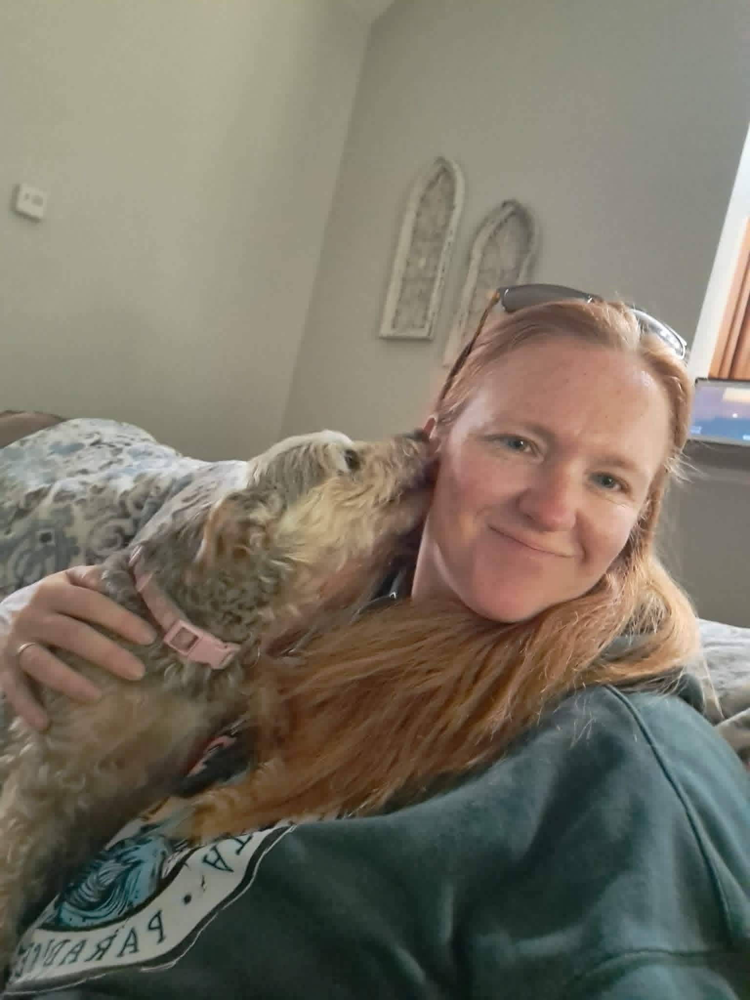 Izzy giving Kim kisses on the couch